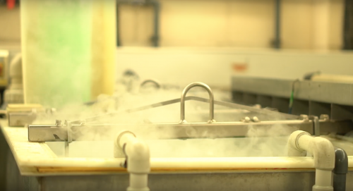 Electroless nickel plating tanks with steam rising from the tank surface